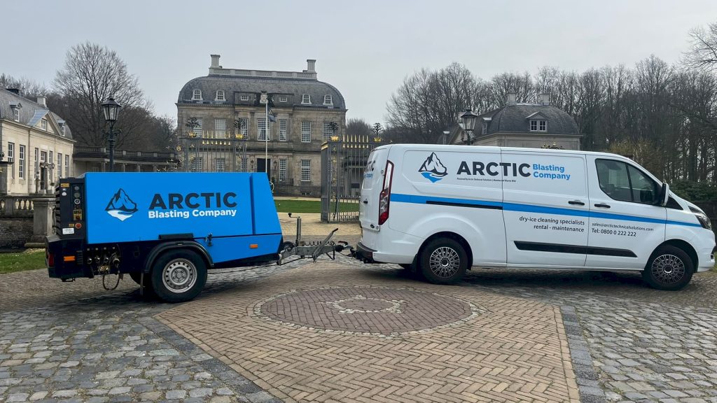 Bedrijfsbus en verrijdbare compressor van Arctic Blasting Company
